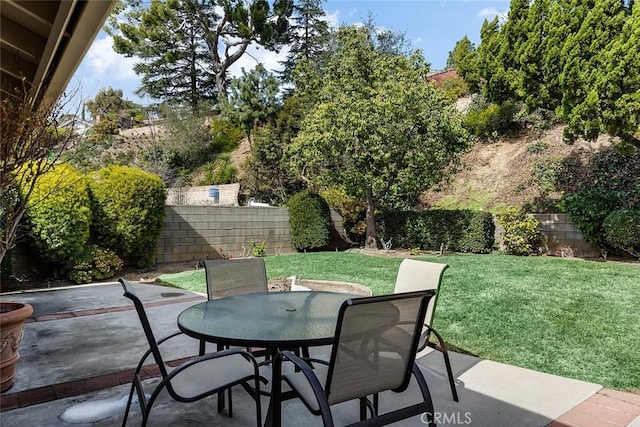 view of patio with outdoor dining space and fence