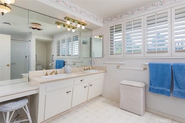 bathroom featuring double vanity, a sink, toilet, and tile patterned floors