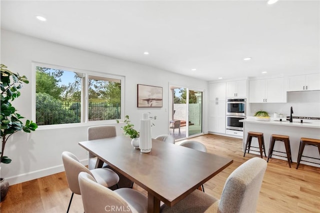 dining area with recessed lighting, baseboards, and light wood finished floors