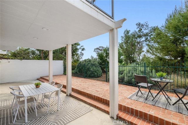 view of patio with a fenced backyard and outdoor dining area