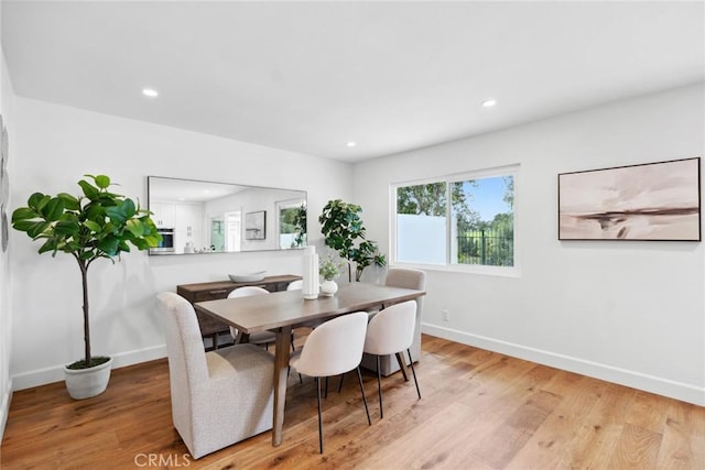 dining space featuring recessed lighting, baseboards, and wood finished floors