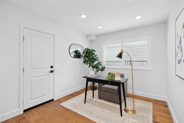 home office featuring light wood finished floors, recessed lighting, and baseboards