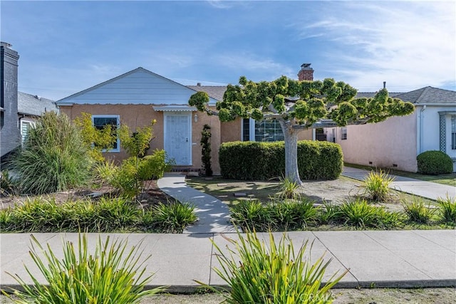 3722 Degnan Blvd, Los Angeles, CA 90018 - view of front of home with a chimney and stucco siding
