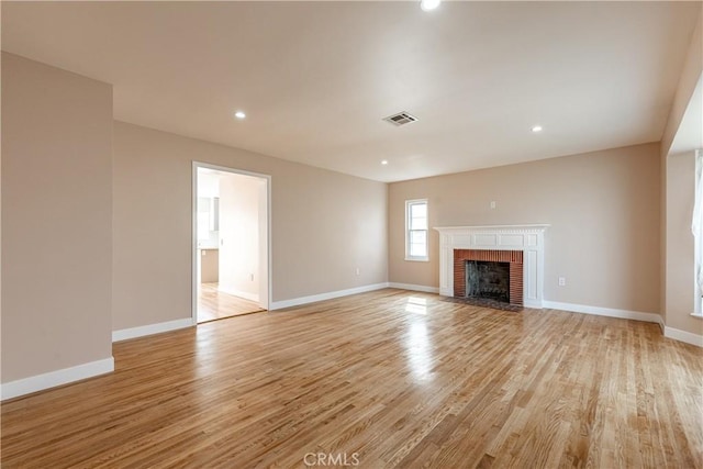 3722 Degnan Blvd, Los Angeles, CA 90018 - unfurnished living room with a brick fireplace, light wood-style floors, baseboards, and recessed lighting