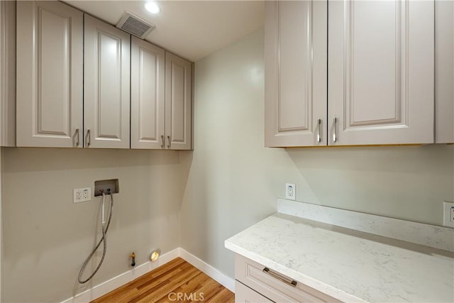 3722 Degnan Blvd, Los Angeles, CA 90018 - laundry room with hookup for a gas dryer, cabinet space, baseboards, hookup for a washing machine, and light wood-style flooring