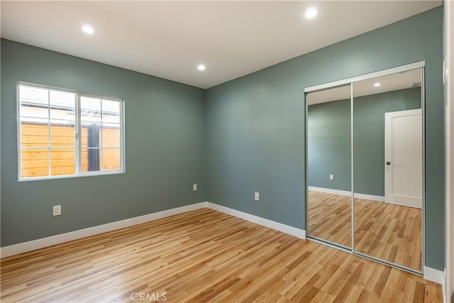 3722 Degnan Blvd, Los Angeles, CA 90018 - unfurnished bedroom featuring light wood finished floors, a closet, baseboards, and recessed lighting