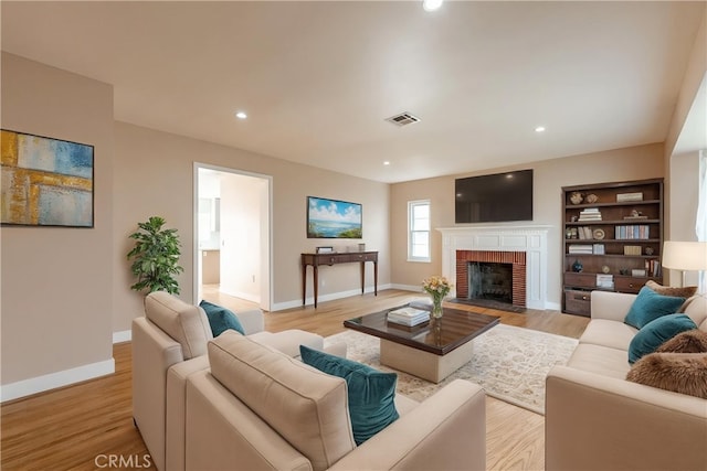 3722 Degnan Blvd, Los Angeles, CA 90018 - living room featuring a fireplace, baseboards, light wood-type flooring, built in features, and recessed lighting