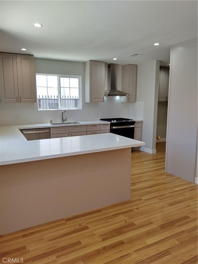 3722 Degnan Blvd, Los Angeles, CA 90018 - kitchen with wall chimney exhaust hood, black range, a sink, stainless steel dishwasher, and light wood-type flooring