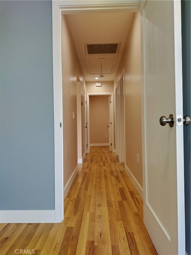 3722 Degnan Blvd, Los Angeles, CA 90018 - corridor featuring attic access, light wood finished floors, and baseboards