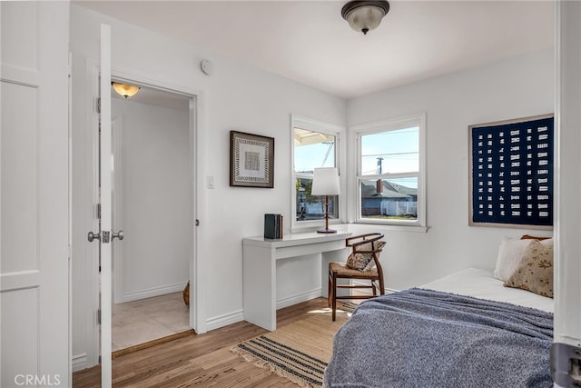 bedroom featuring light wood-type flooring and baseboards