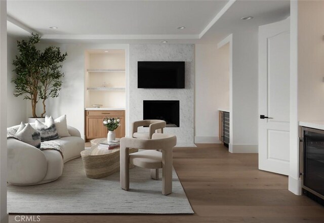 31 Vista Tramonto, Newport Coast, CA 92657 - living room with wine cooler, light wood-style flooring, built in features, a large fireplace, and recessed lighting
