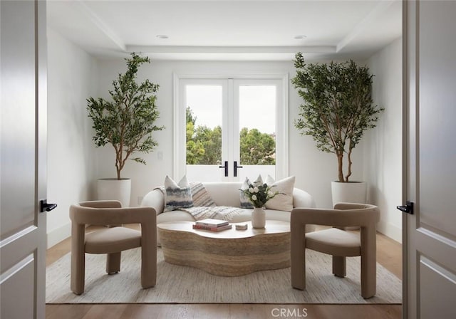 living area featuring light wood-type flooring and french doors