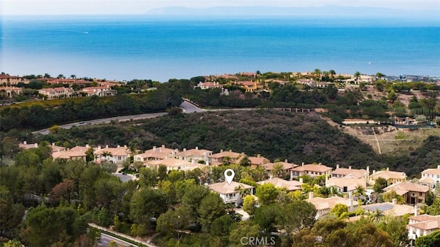 drone / aerial view featuring a residential view and a water view