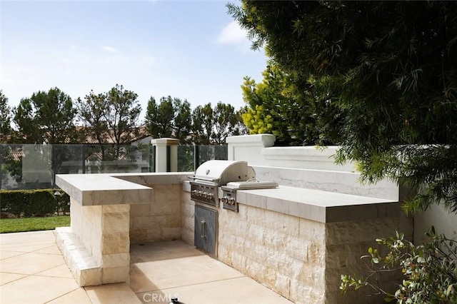view of patio / terrace with area for grilling and fence