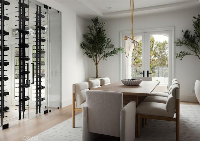 dining space with wood finished floors and baseboards