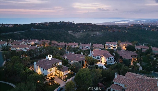aerial view at dusk featuring a residential view