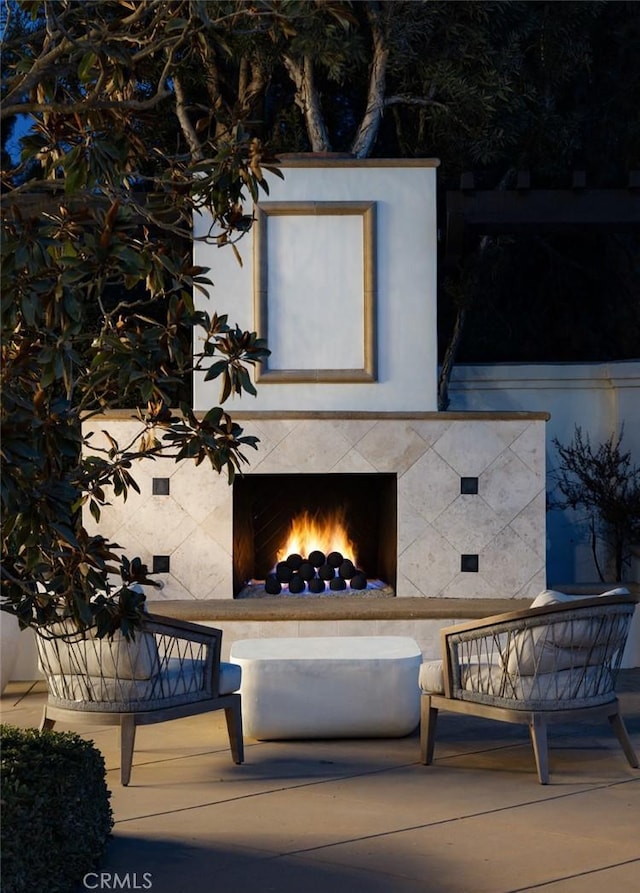 view of patio / terrace with a warm lit fireplace