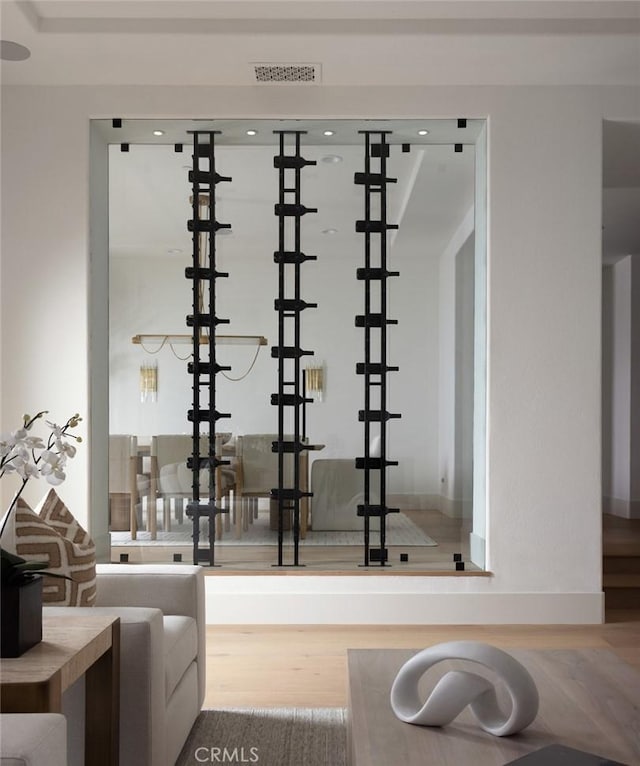 wine area featuring visible vents and wood finished floors