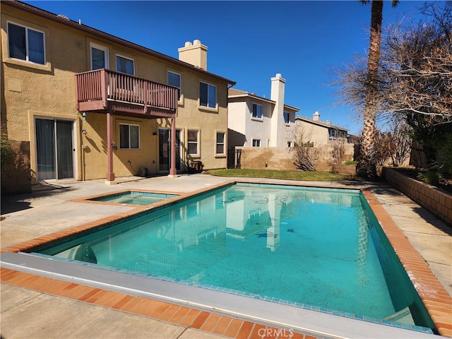 view of swimming pool featuring a fenced in pool, a patio area, and an in ground hot tub