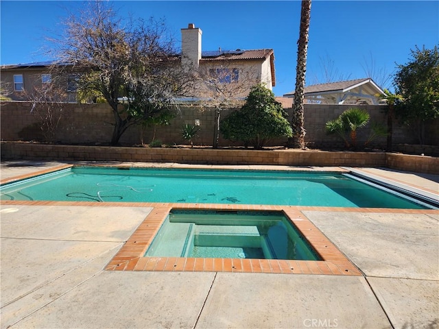 view of swimming pool featuring a fenced backyard, a fenced in pool, and an in ground hot tub