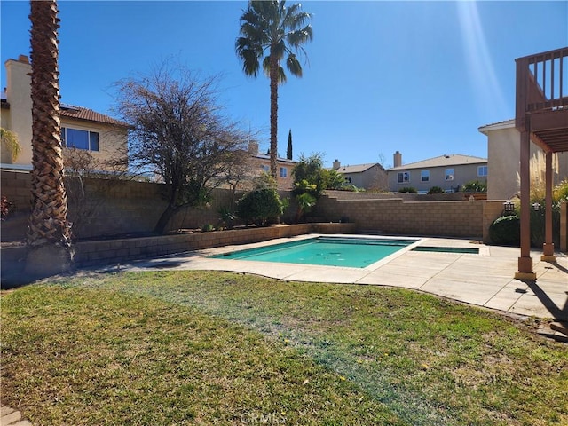 view of swimming pool featuring a patio, a yard, a fenced backyard, and a fenced in pool