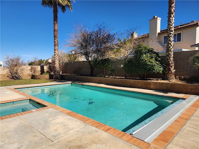 view of pool with a fenced in pool, a fenced backyard, and an in ground hot tub