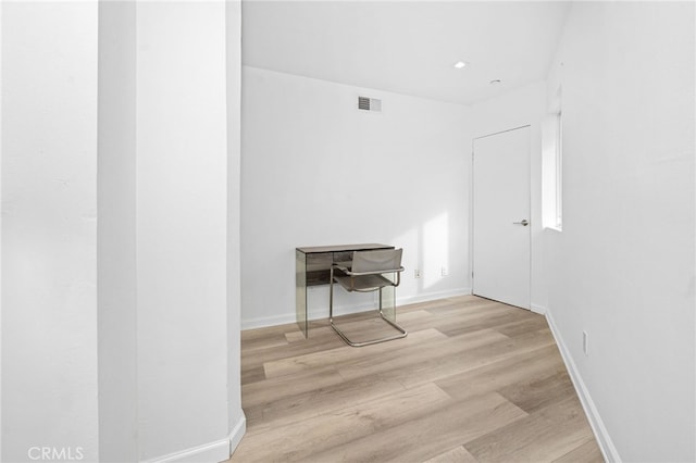 unfurnished room featuring visible vents, baseboards, and wood finished floors