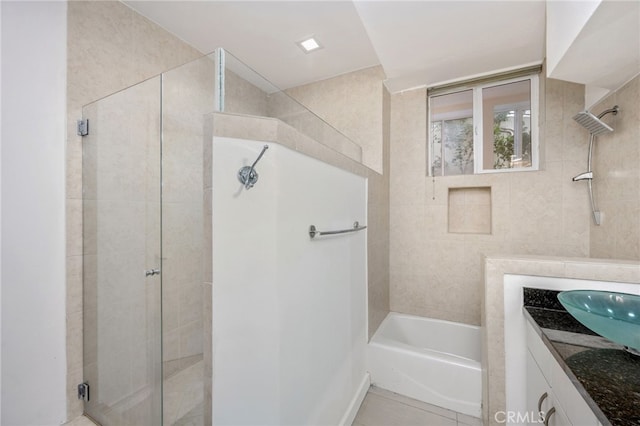 bathroom with a washtub, tile patterned flooring, a shower stall, and vanity