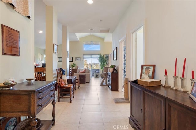 hallway with recessed lighting, light tile patterned flooring, and vaulted ceiling