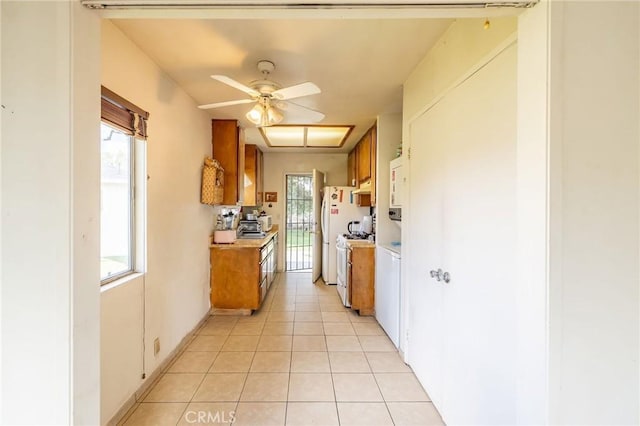 kitchen with light tile patterned floors, light countertops, a ceiling fan, and brown cabinetry