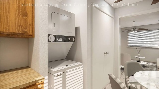 interior space featuring ceiling fan and stacked washer and clothes dryer