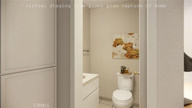 bathroom with toilet, vanity, and tile patterned floors