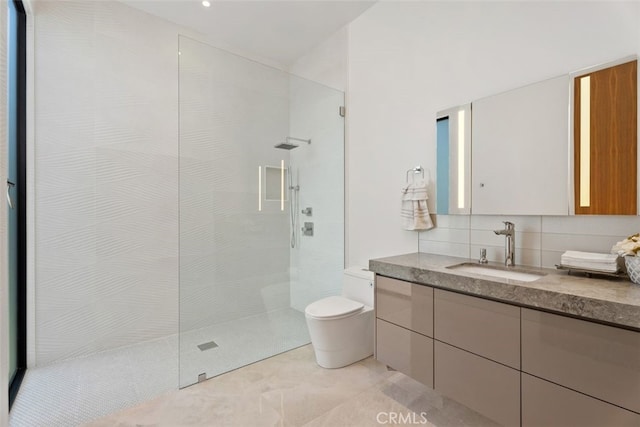 bathroom featuring toilet, walk in shower, backsplash, and vanity