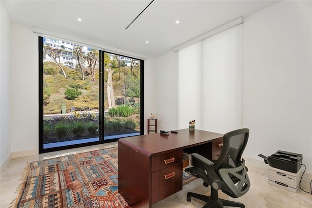 office area with plenty of natural light, floor to ceiling windows, baseboards, and recessed lighting