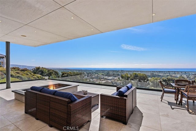 view of patio / terrace with an outdoor living space with a fire pit