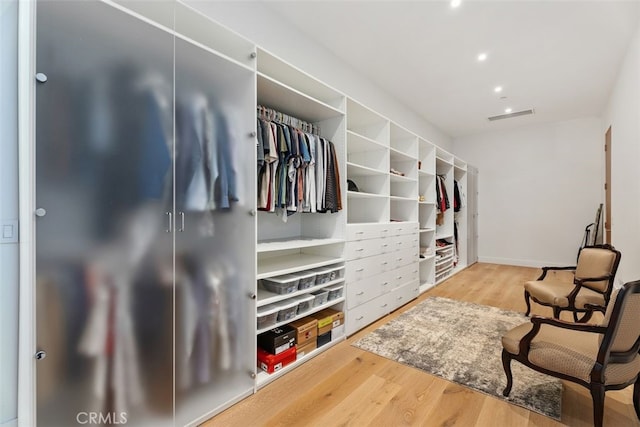 walk in closet featuring visible vents and wood finished floors