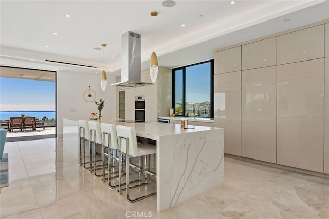 kitchen with a wealth of natural light, a large island, island range hood, and modern cabinets