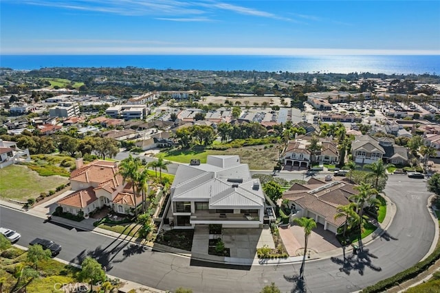 birds eye view of property with a water view and a residential view