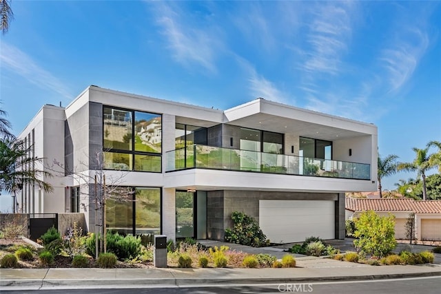 view of front facade featuring a balcony and a garage