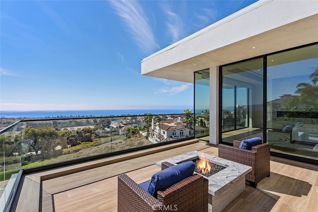 wooden deck featuring an outdoor fire pit