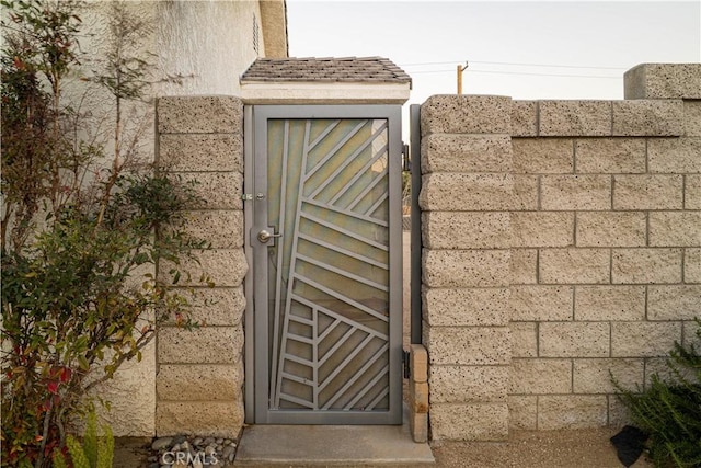 view of gate with fence