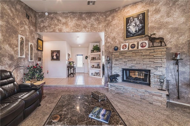 tiled living area with a fireplace and visible vents