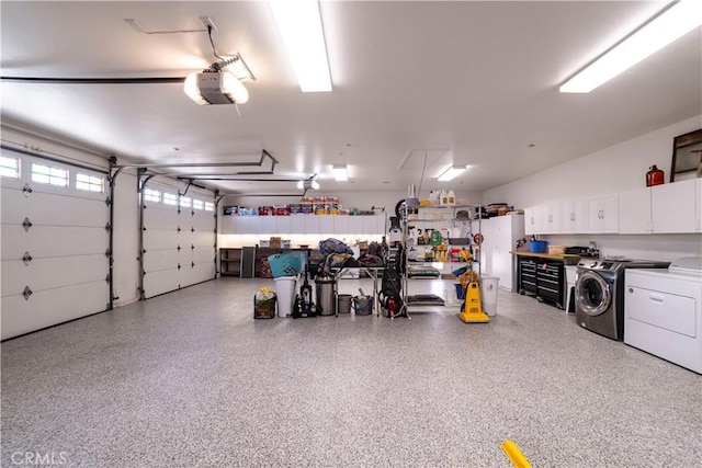 garage with refrigerator, washing machine and clothes dryer, and a garage door opener