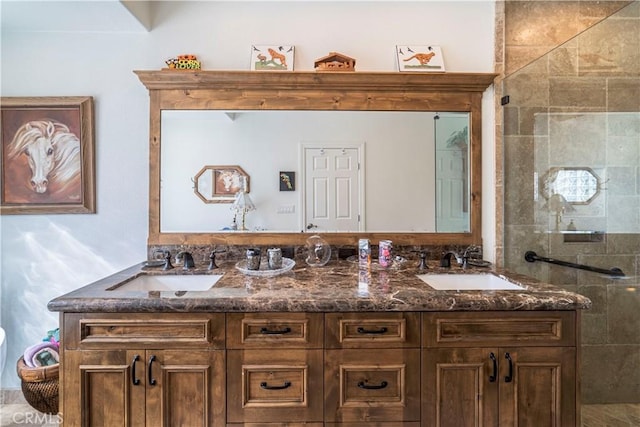 full bathroom featuring a sink, a tile shower, and double vanity