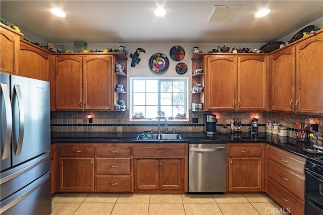 kitchen featuring open shelves, appliances with stainless steel finishes, a sink, and visible vents