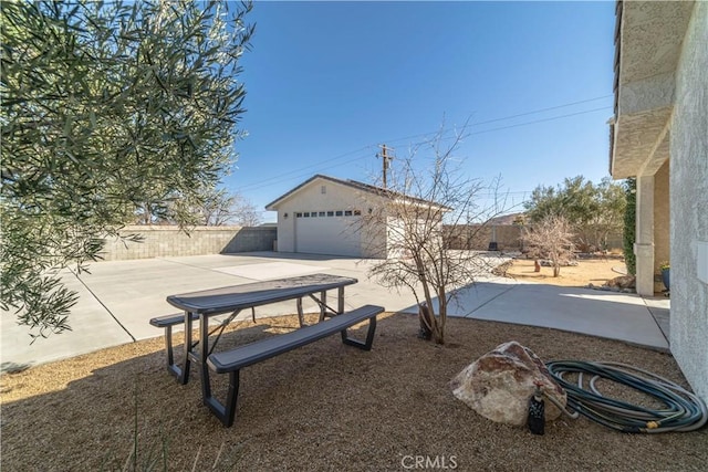 view of yard featuring an outbuilding, a patio area, and a fenced backyard