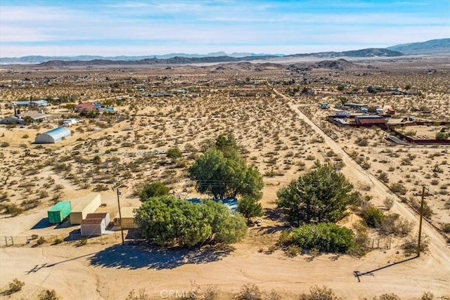 aerial view featuring a desert view and a mountain view