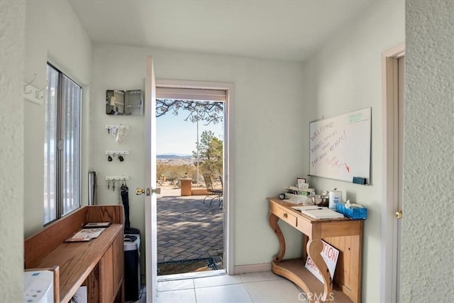 doorway to outside featuring light tile patterned flooring