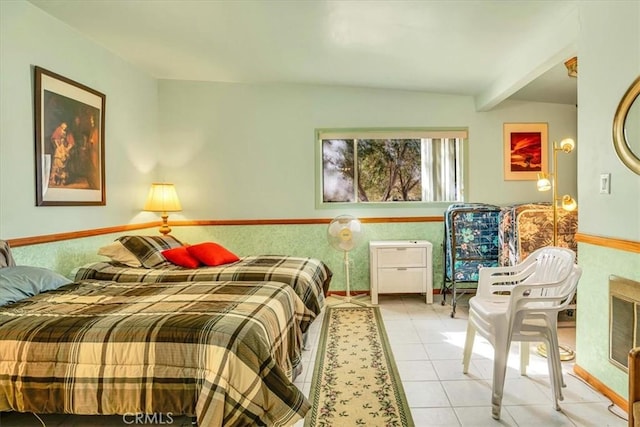 bedroom featuring light tile patterned floors and beamed ceiling