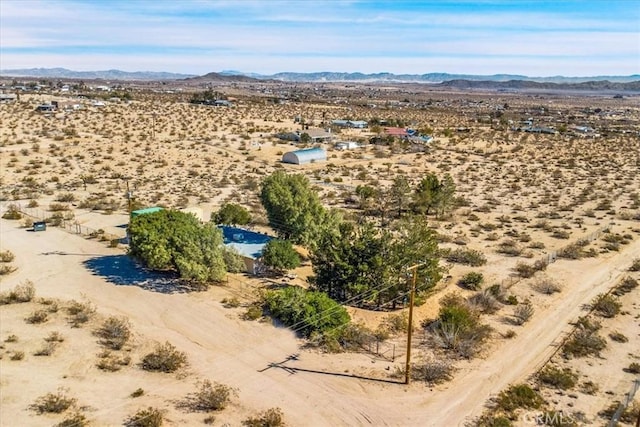 aerial view featuring a desert view and a mountain view